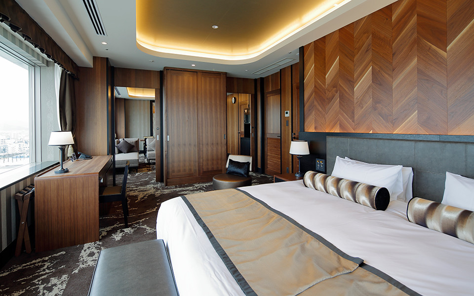 Wood-panelled suite bedroom at Hotel Monterey Himeji